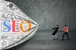 Two people pulling a large illustrated SEO concept banner with terms like 'traffic,' 'link,' 'PPC,'