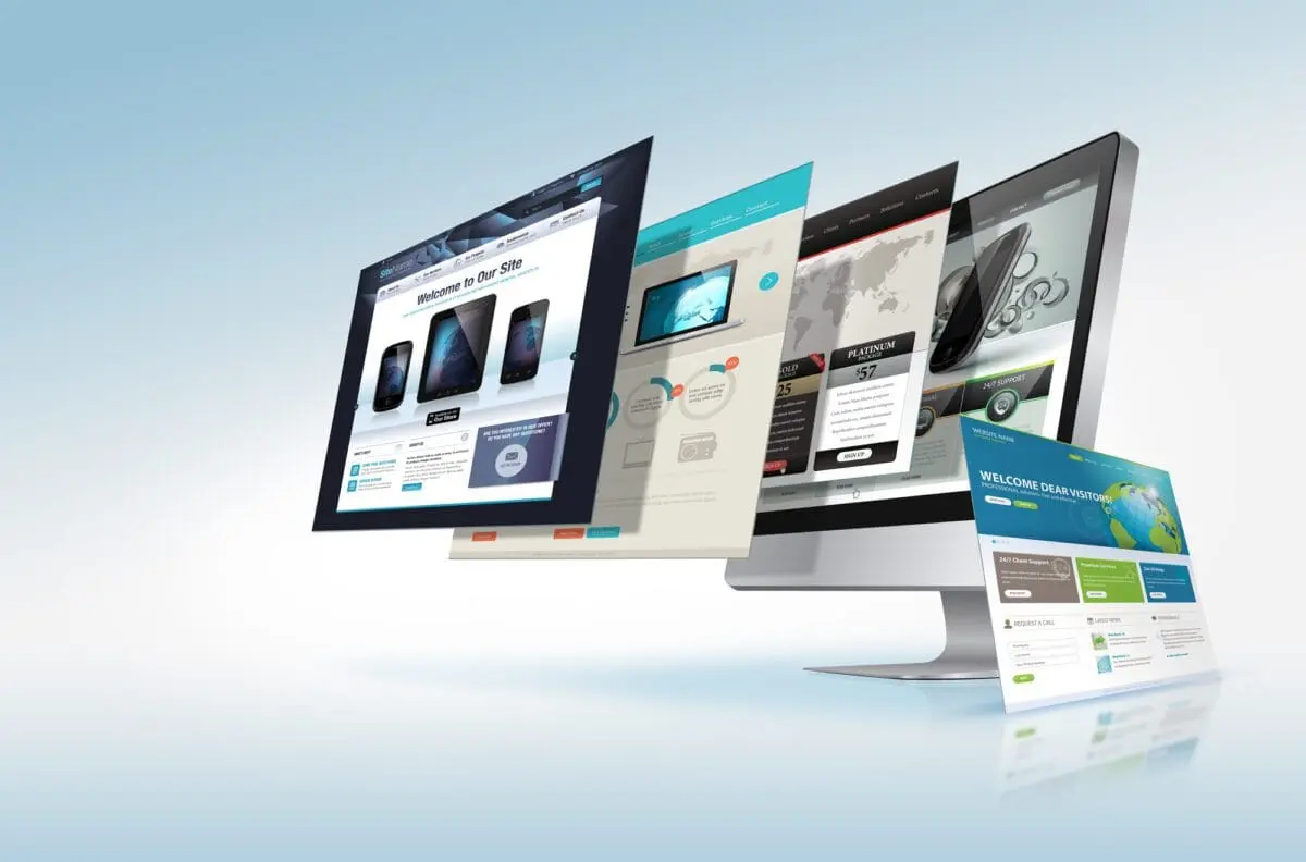 Computer monitor displaying multiple layered website design layouts representing web development