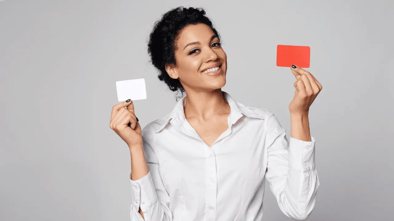 a woman holding two blank business cards