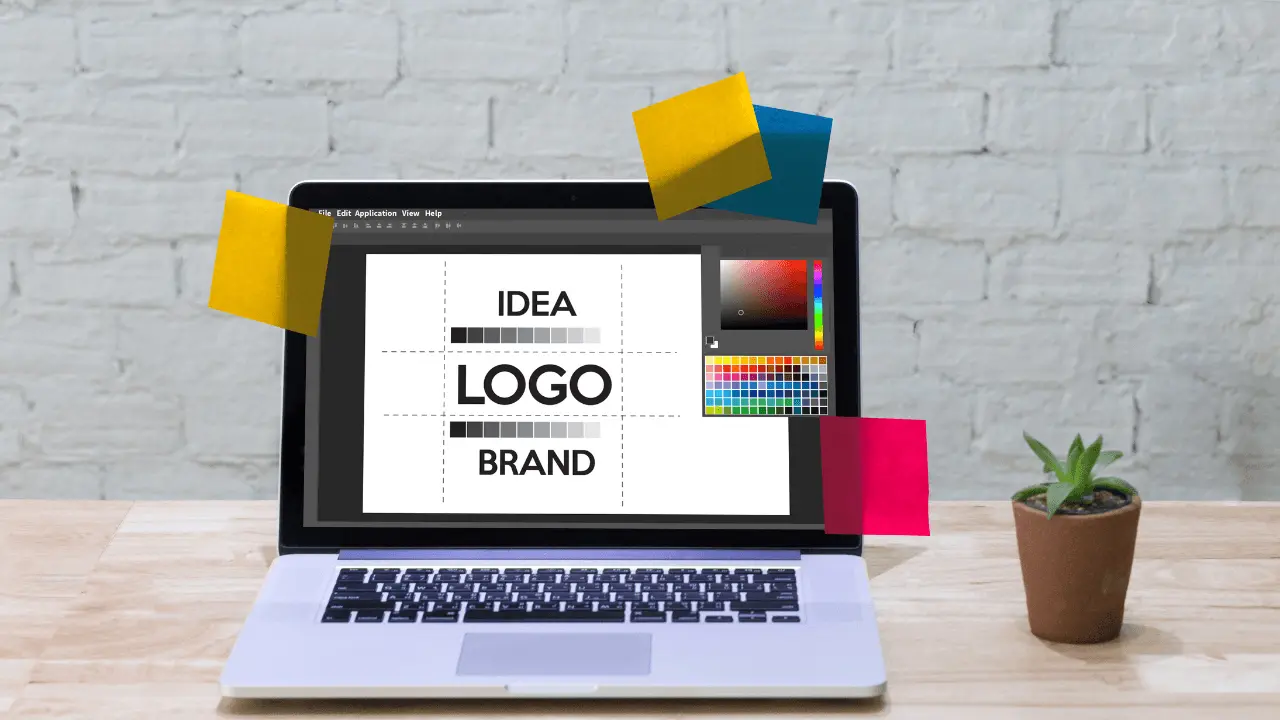 A laptop with colourful sticky noteson it and a design software open on display.
