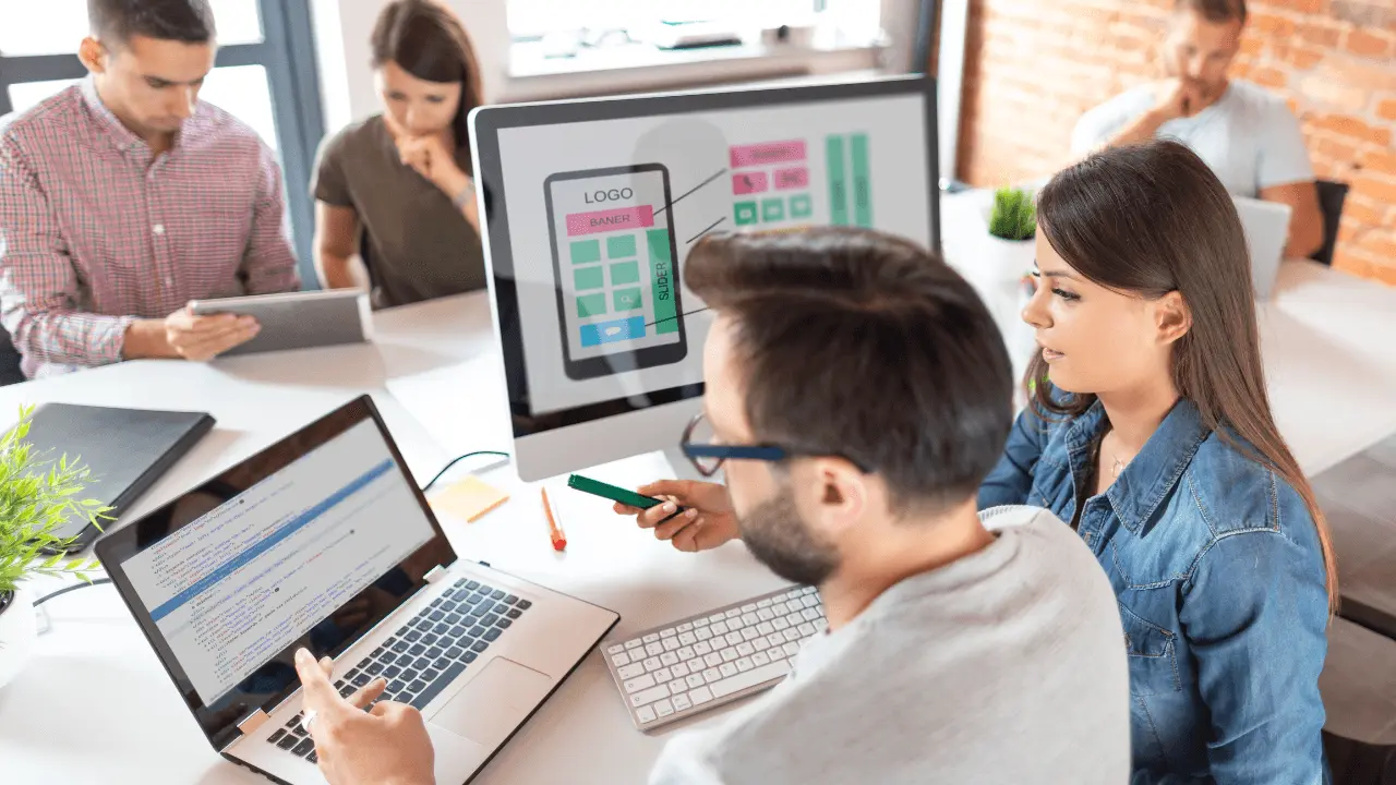 A group of people in an office setting.