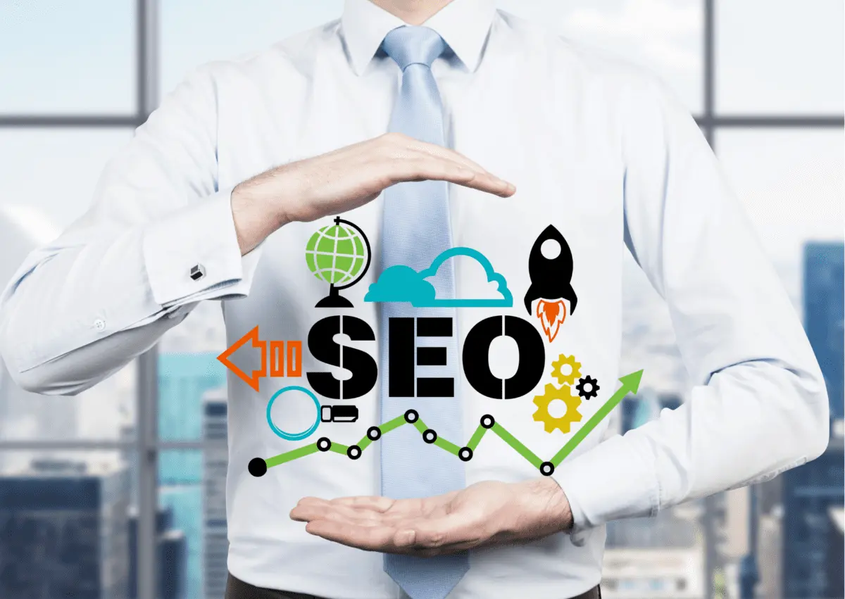 Businessman holding an illustrated SEO graphic with icons for global reach, cloud, rocket