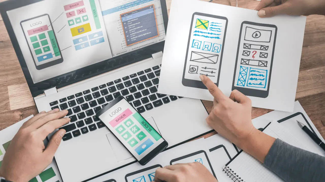 Individuals planning the design layout of a website.
