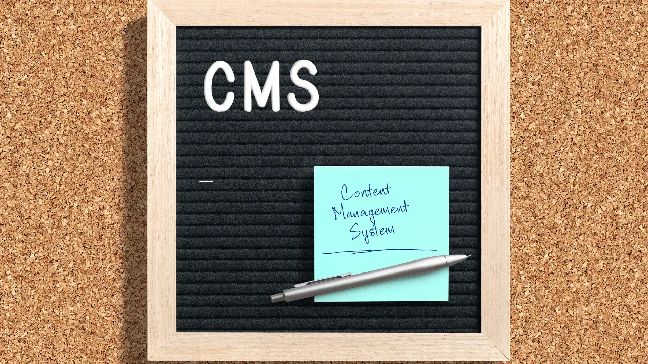 The letters CMS stacked on a black letter board.