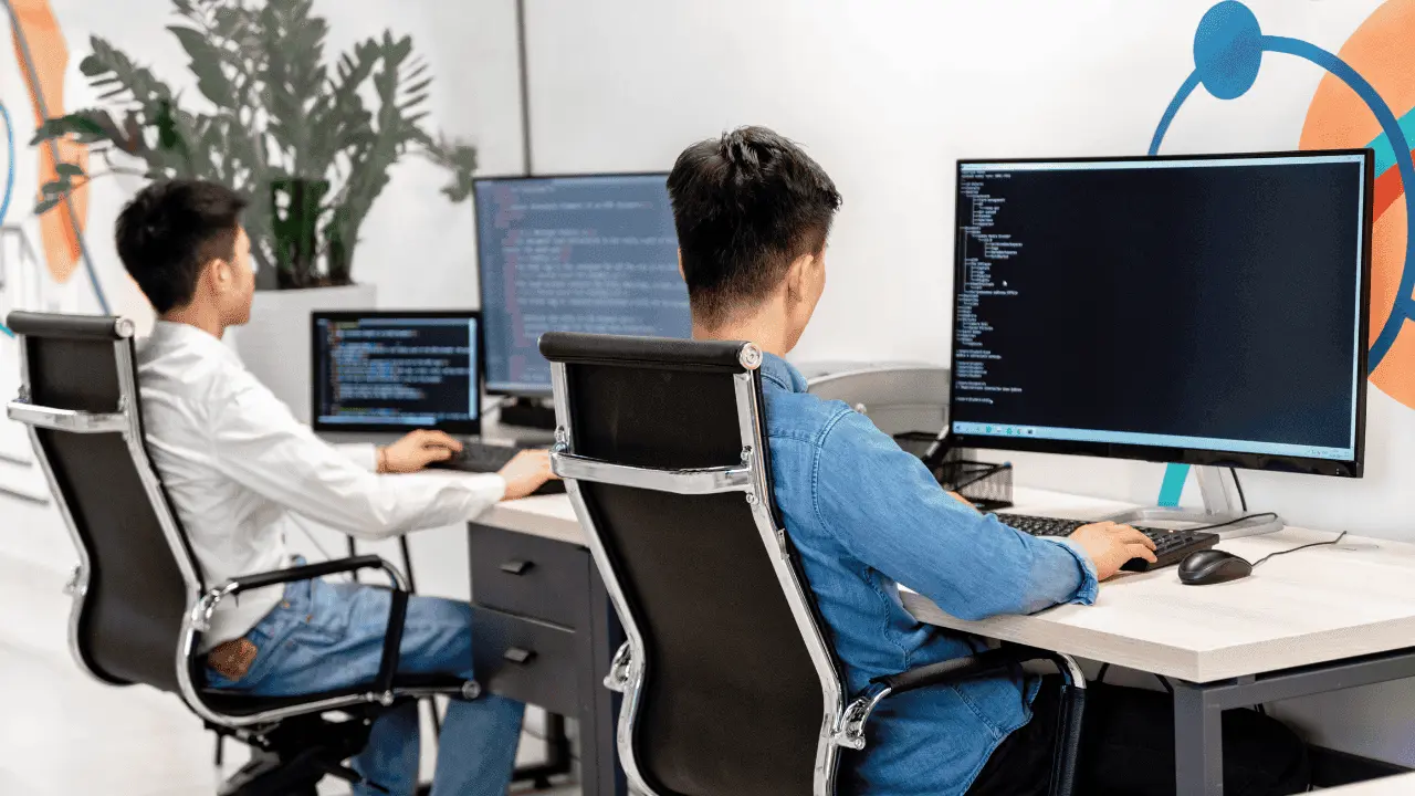 Two people sitting in a web development agency environment.